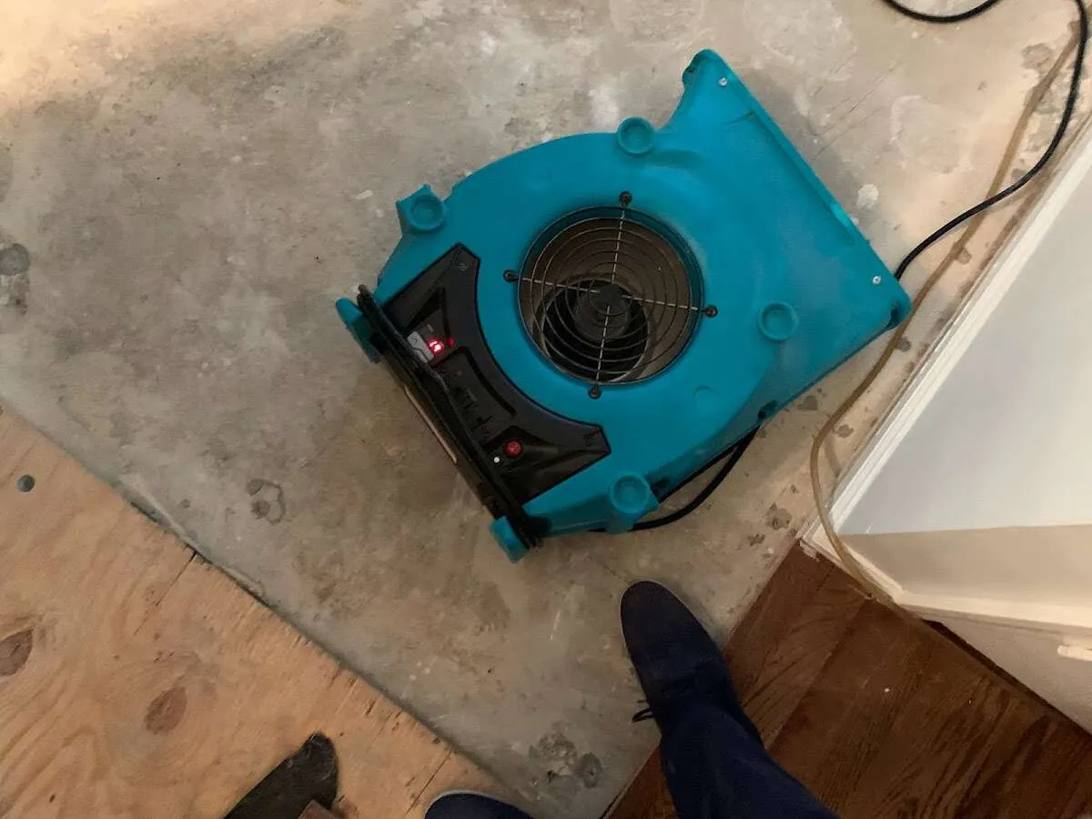 Air mover drying subfloor during Leak Detection & Repair in Pierre